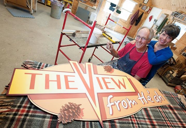 Completing portable television sign (acrylics on wood) (Photo by Kevin Barrett)